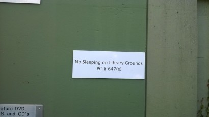 A szabadtéri alvást jogszabályi hivatkozással alátámasztva tiltotta meg egy tábla a berkeley-i közkönyvtár falán, miközben a táblától nem messze számos hajléktalan ült és feküdt az aszfalton. Csináljunk valamit – a fotón kívül?